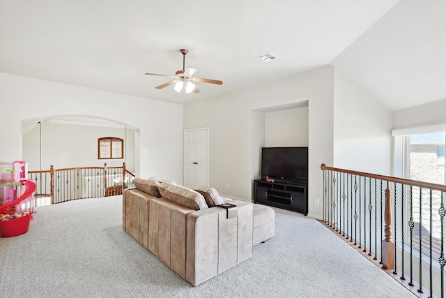 carpeted living room with vaulted ceiling and ceiling fan