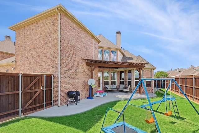 back of house with a lawn, a playground, a patio, and a pergola