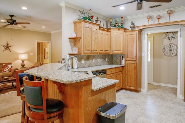 kitchen featuring light stone counters, a kitchen breakfast bar, kitchen peninsula, ceiling fan, and ornamental molding