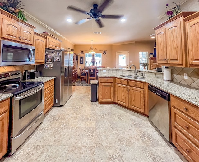 kitchen featuring appliances with stainless steel finishes, a healthy amount of sunlight, sink, and ceiling fan