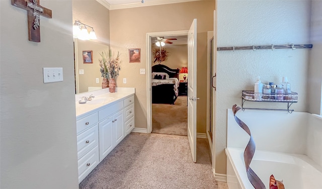 bathroom with vanity, ceiling fan, ornamental molding, and a washtub