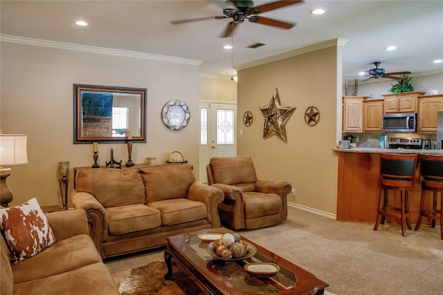 living room with crown molding, light colored carpet, and ceiling fan