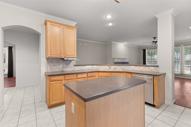 kitchen featuring dishwasher, tasteful backsplash, kitchen peninsula, ceiling fan, and light wood-type flooring