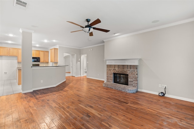 unfurnished living room with ceiling fan, hardwood / wood-style flooring, a fireplace, and ornamental molding