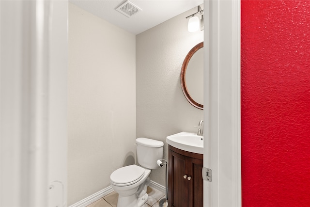 bathroom featuring tile patterned flooring, vanity, and toilet