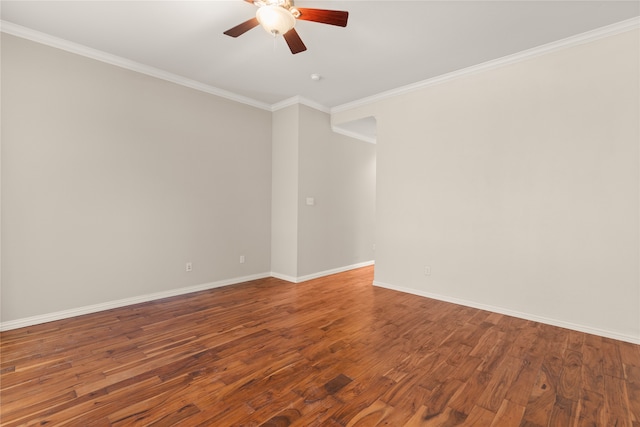 empty room featuring ornamental molding, dark hardwood / wood-style flooring, and ceiling fan