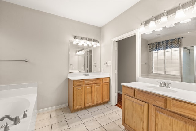 bathroom with tile patterned flooring, a washtub, and vanity