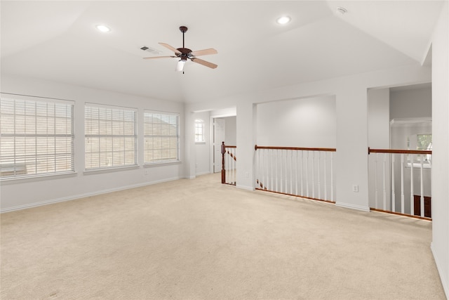 carpeted spare room with lofted ceiling and ceiling fan