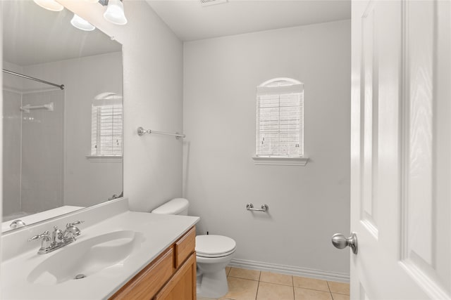 bathroom featuring vanity, walk in shower, toilet, tile patterned floors, and plenty of natural light