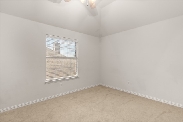 unfurnished room featuring lofted ceiling, ceiling fan, and light carpet