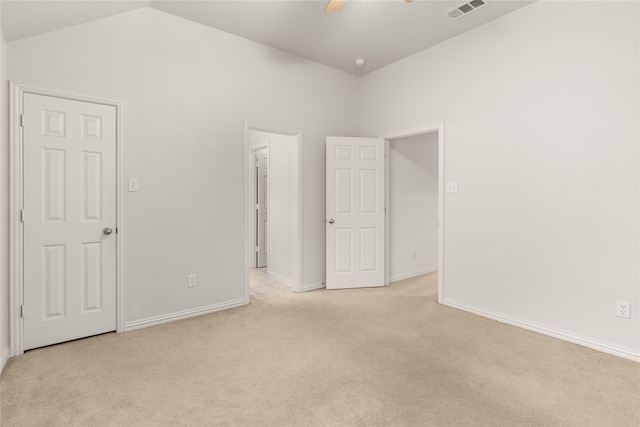 carpeted empty room featuring lofted ceiling and ceiling fan