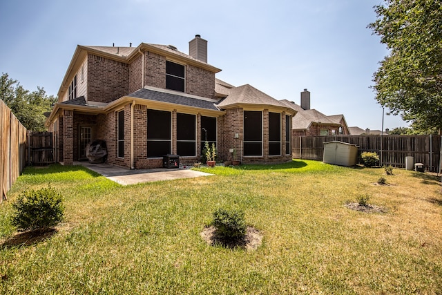 back of property featuring a lawn and a patio