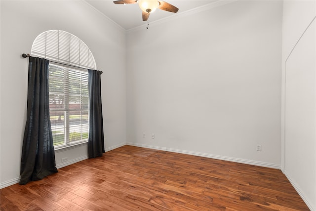 empty room with ceiling fan, ornamental molding, and wood-type flooring