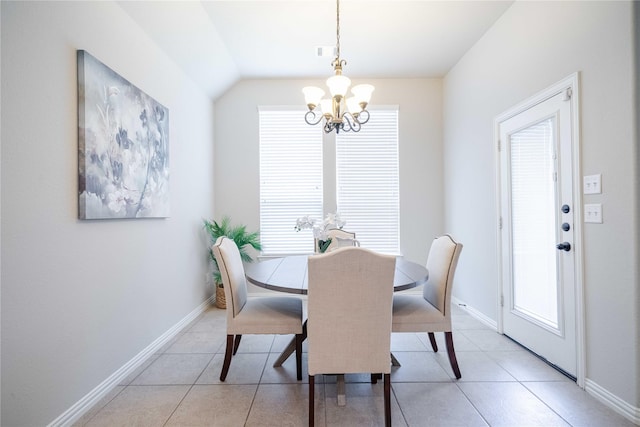 dining area featuring a healthy amount of sunlight, a notable chandelier, and light tile patterned flooring