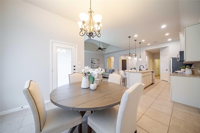 dining room with arched walkways, light tile patterned floors, recessed lighting, baseboards, and ceiling fan with notable chandelier