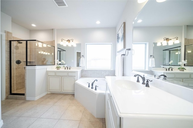 bathroom with a stall shower, visible vents, a garden tub, tile patterned flooring, and a sink