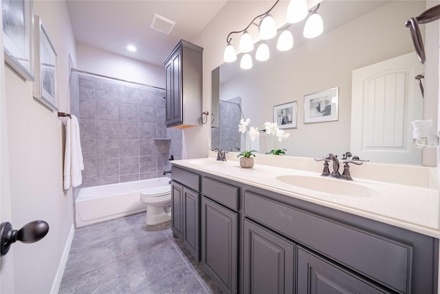 full bath featuring double vanity, bathtub / shower combination, a sink, and toilet