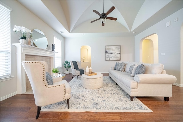 living area with lofted ceiling, plenty of natural light, and wood finished floors