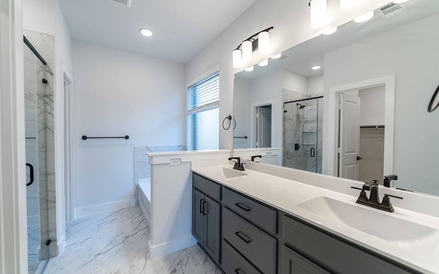 bathroom featuring vanity and shower with separate bathtub