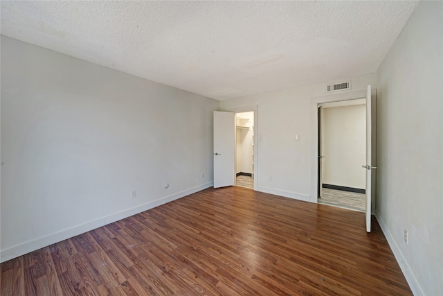 interior space featuring dark hardwood / wood-style flooring and a textured ceiling