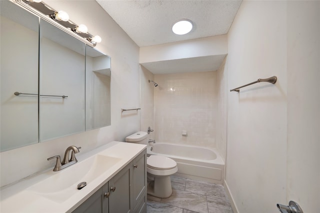 full bathroom with tiled shower / bath, tile patterned floors, toilet, vanity, and a textured ceiling