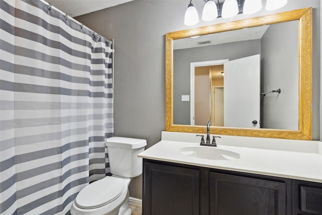 bathroom with a textured ceiling, a textured wall, toilet, visible vents, and vanity