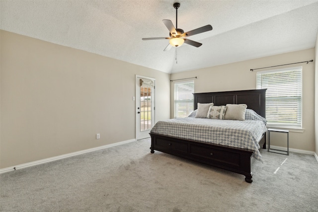 carpeted bedroom with ceiling fan, access to outside, and a textured ceiling