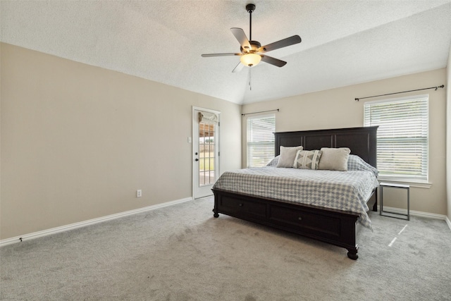 bedroom featuring lofted ceiling, access to exterior, light carpet, and baseboards