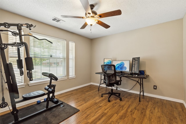 office featuring ceiling fan, dark hardwood / wood-style flooring, and a textured ceiling