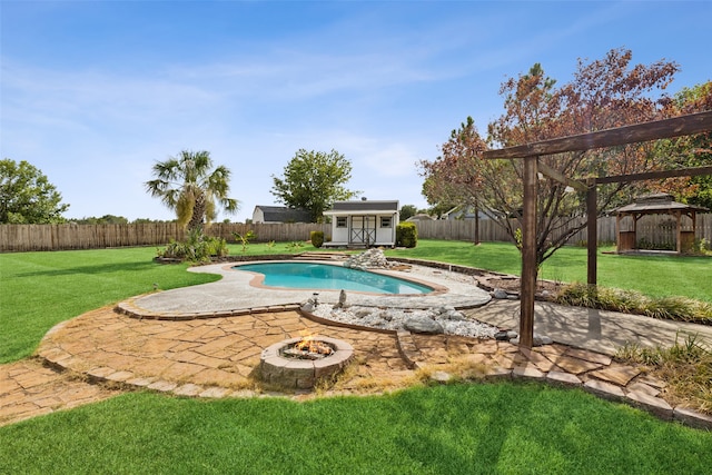 view of pool with a lawn, an outdoor fire pit, a gazebo, a storage shed, and a patio