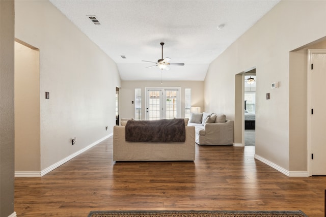 living room with vaulted ceiling, a textured ceiling, ceiling fan, and dark hardwood / wood-style floors