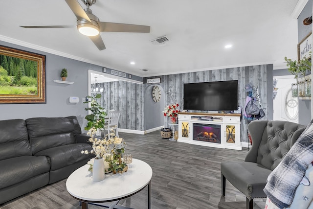 living room featuring hardwood / wood-style flooring, ornamental molding, and ceiling fan