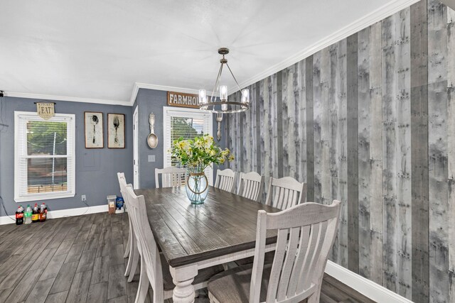 dining area featuring plenty of natural light, baseboards, crown molding, and wood finished floors