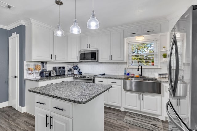 kitchen with white cabinetry, sink, a center island, and appliances with stainless steel finishes