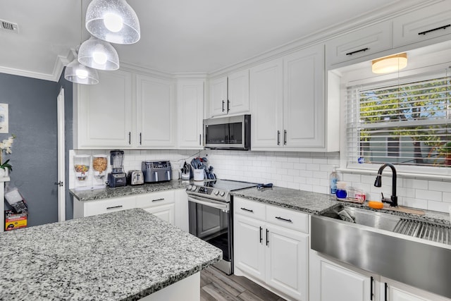 kitchen featuring white cabinetry and appliances with stainless steel finishes