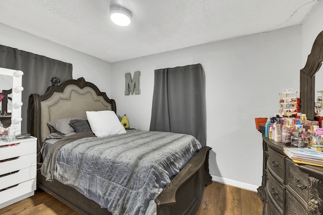 bedroom with dark hardwood / wood-style floors and ceiling fan