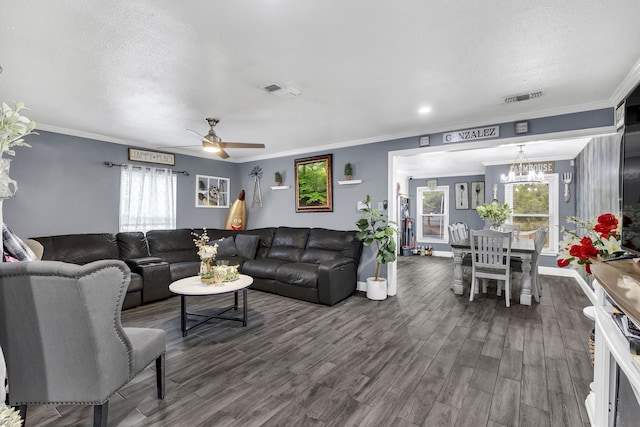 living room featuring dark wood-style floors, visible vents, and ornamental molding