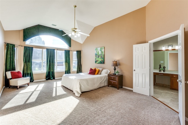 carpeted bedroom featuring ceiling fan, high vaulted ceiling, and connected bathroom