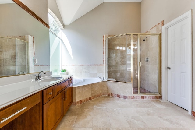 full bath with lofted ceiling, a stall shower, vanity, and a bath