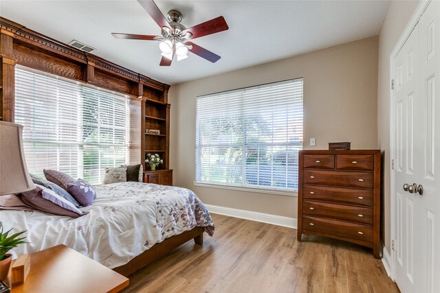 bedroom with light hardwood / wood-style flooring and ceiling fan