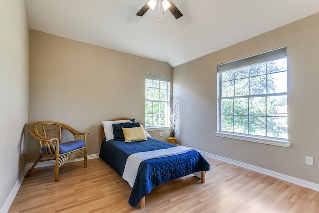 bedroom with lofted ceiling, ceiling fan, and light hardwood / wood-style flooring