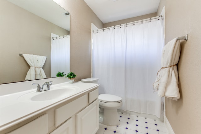 bathroom with tile patterned flooring, toilet, and vanity