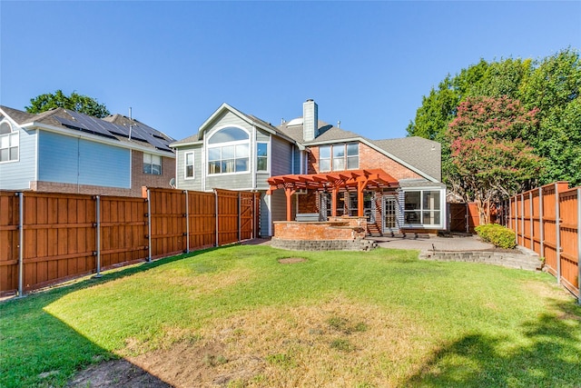 rear view of house featuring a yard, a chimney, a patio area, a pergola, and a fenced backyard