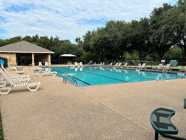 pool featuring a patio and fence