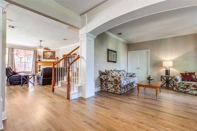 sitting room featuring crown molding, ceiling fan, light wood-type flooring, and decorative columns