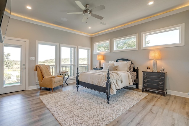 bedroom featuring access to exterior, light hardwood / wood-style flooring, and ceiling fan