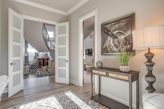 interior space featuring hardwood / wood-style flooring, crown molding, and french doors