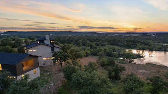 aerial view at dusk with a water view