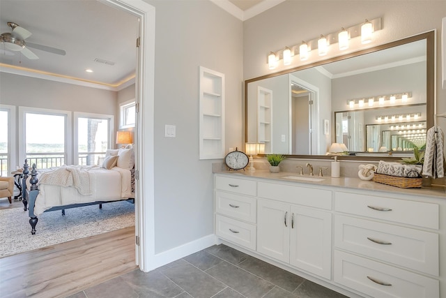 bathroom with ceiling fan, vanity, wood-type flooring, and ornamental molding