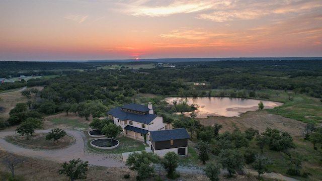 aerial view at dusk with a water view